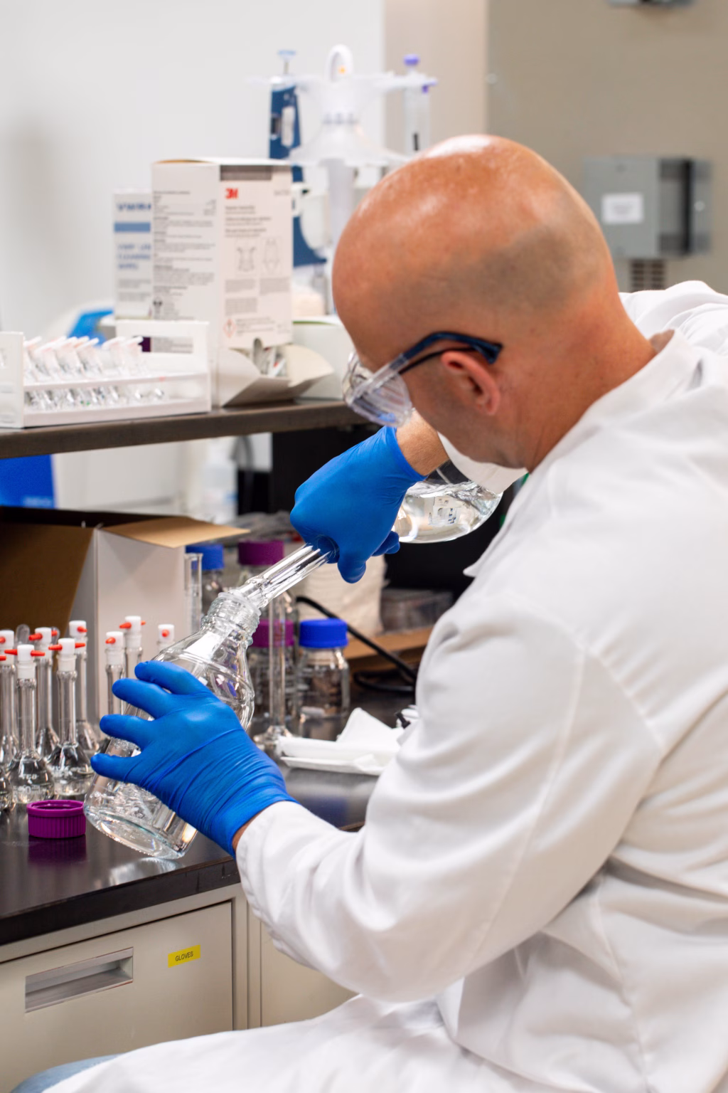 Formulation scientist mixing solution in lab