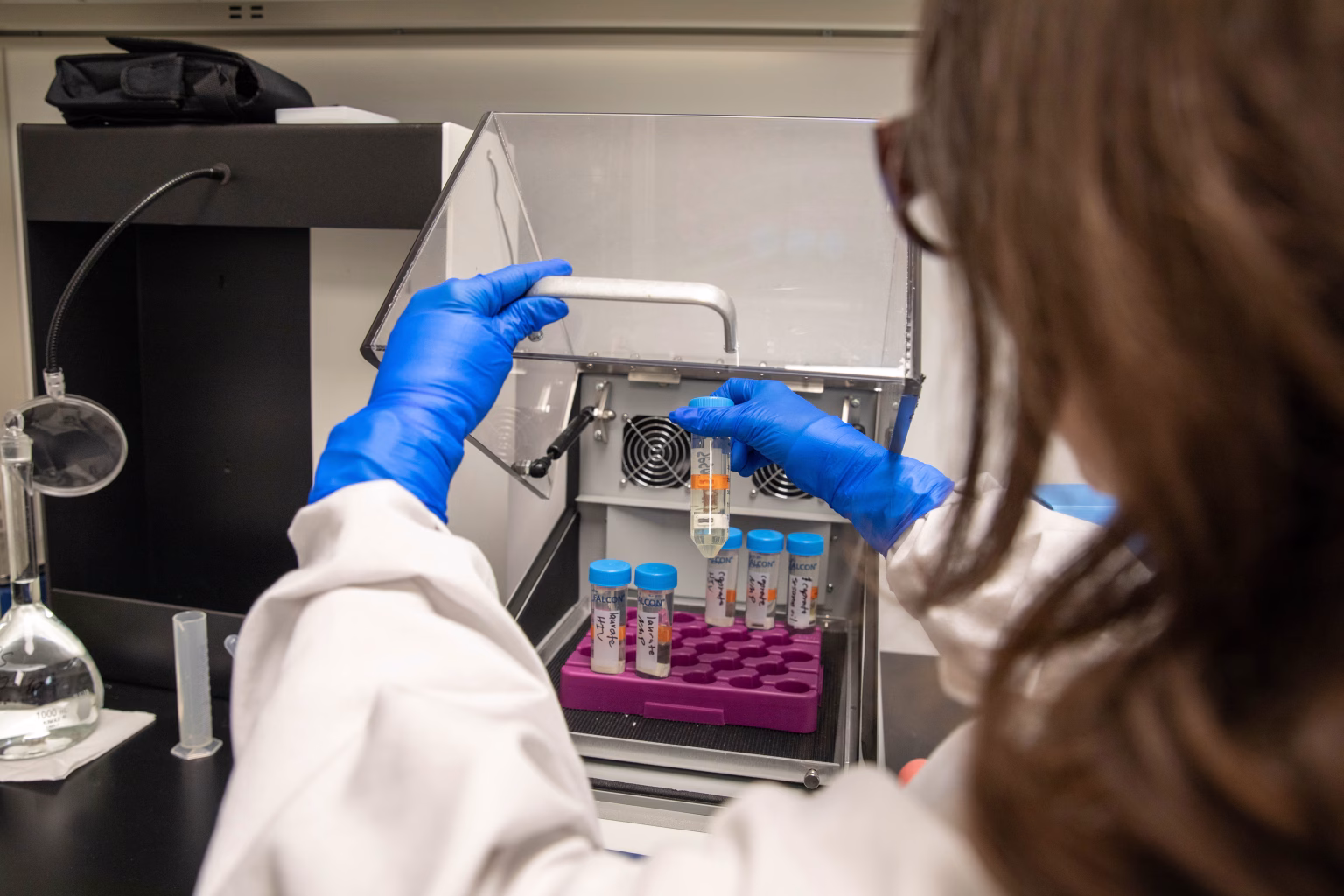 Analytical Chemist with vials of drug product in laboratory